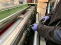 Technician worker placing the blades of a machine to cut steel coils Royalty Free Stock Photo