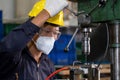 Technician or worker wearing a glove and safety glass control drilling machine to screw iron. Work in manufacturing factory.