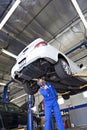 Technician working on car at automobile repair shop Royalty Free Stock Photo