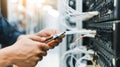 Technician working with network cables, cutting or installing internet connection on server racks Royalty Free Stock Photo