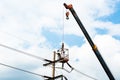 Technician works in a bucket high up on a power pole Royalty Free Stock Photo
