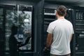 Data center technician checks server hardware in a modern server room for network maintenance and monitoring Royalty Free Stock Photo