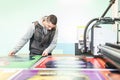 Technician works on large CNC computer numerical control cutting machine