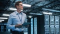 IT Technician Works on Tablet Computer in Big Data Center at Night. He Runs Diagnostics and Mainte Royalty Free Stock Photo
