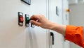 Technician& x27;s hand turning a switch on an industrial control panel. Worker operating electrical equipment in a factory. Power Royalty Free Stock Photo