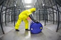 Technician in yellow uniform rolling the barrel wi Royalty Free Stock Photo