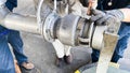 Industrial Workers Installing Metal Pipe Coupling Connection Royalty Free Stock Photo