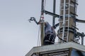 2 technicians carry out repairs on a radio mast