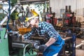 technicians Caucasian man are working by controlling steel lathes