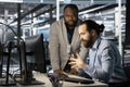 Technicians in data center office using computer, verifying firewall configurations Royalty Free Stock Photo