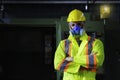 Technicians and engineers are working on machines in a factory. Caucasian man wear safety clothing in the industry