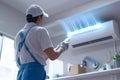 Technicians hand activates air conditioner with remote control, repair underway Royalty Free Stock Photo