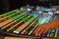 Technicians hands working on a video switcher