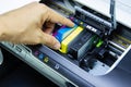 Technicians are install setup the ink cartridge of a inkjet printer the device of office automate