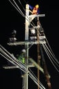 Technicians Working on Electrical Pole at Night