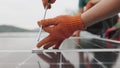 Technicians installing solar panels on metal stand. Workers installing solar panels on the roof of a house. Close-up Royalty Free Stock Photo