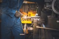 Technicians man are working by controlling steel lathes, in parts production line Royalty Free Stock Photo