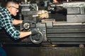 Technicians man are working by controlling steel lathes, in parts production line Royalty Free Stock Photo