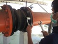 Coupling flange. The worker tightens the bolts on the Rubber Expansion Joint with a wrench for Cooling Tower.