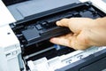 Technicians replacing toner in laser printer