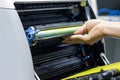 Technicians replacing toner in laser printer concept office supplies repair