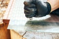 Cutting glass by glass cutter. Man hands with gloves holding glass cutter. Royalty Free Stock Photo