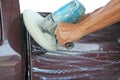 Automotive paint technician using grinder machine with wax on side of pickup , A part of the procedure to make a new color car