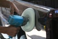 Automotive paint technician using grinder machine with wax on side of pickup , A part of the procedure to make a new color car Royalty Free Stock Photo