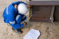 Technicians are using measuring tape to checking the accuracy of the steel structure Royalty Free Stock Photo