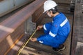 Technicians are using measuring tape to checking the accuracy of the steel structure