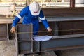 Technicians are using measuring tape to checking the accuracy of the steel structure Royalty Free Stock Photo