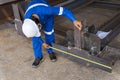 Technicians are using measuring tape to checking the accuracy of the steel structure after assembly before delivery to paint Royalty Free Stock Photo