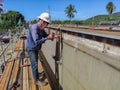 Technicians are using measuring tape to checking the accuracy of the steel top flange after assembly before welding Royalty Free Stock Photo