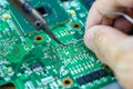 Technicians are using a soldering iron for repairing electronic