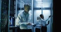 Technicians work on a laptop in a data center Royalty Free Stock Photo