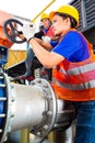 Technicians working on valve in factory or utility Royalty Free Stock Photo