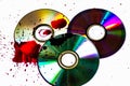 Technological background created with the photo of three wet CDs, the light accentuates the reflections coloring them. Royalty Free Stock Photo