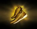 Technological golden running shoes with a flash of light in the dark Royalty Free Stock Photo