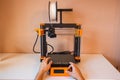 Technological hi-teg tool for making new things. A black and red 3D printer at work. The object is created by laying down Royalty Free Stock Photo