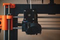 Technological hi-teg tool for making new things. A black and red 3D printer at work. The object is created by laying down Royalty Free Stock Photo