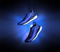 Technological running shoes with a flash of blue light in the dark