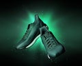 Technological running shoes with a flash of green light in the dark