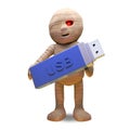 Technologically minded Egyptian mummy monster keeps data on a USB thumb drive, 3d illustration
