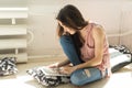 Technologies, communication, people concept - student girl is sitting on the floor and using a laptop or surfing the net Royalty Free Stock Photo