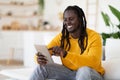 Technologies For Leisure. Black Happy Man Using Digital Tablet At Home Royalty Free Stock Photo