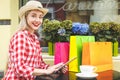 Technologies make shopping easier. Beautiful young woman with shopping bags using her laptop computer with smile while standing at Royalty Free Stock Photo