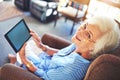 Technology is for anyone at any age. a senior woman using a tablet at home. Royalty Free Stock Photo