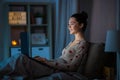 teenage girl with laptop in bed at home at night Royalty Free Stock Photo