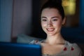 teenage girl with laptop in bed at home at night Royalty Free Stock Photo