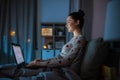 teenage girl with laptop in bed at home at night Royalty Free Stock Photo